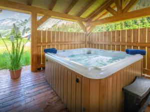 a jacuzzi tub in a wooden house at Chalet Les Vardafes - OVO Network in La Chapelle-dʼAbondance