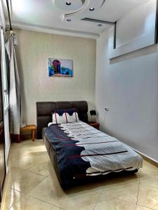 a bedroom with a large bed in a room at Apartment oasis moderne in Tangier +12 photos