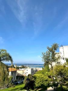 a view of a city with the ocean in the background at Apartment oasis moderne in Tangier
