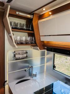 a kitchen with a sink and a counter top at RWay The Moving Hotel by Theo in Budapest