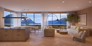 a kitchen and living room with a couch and a table at New designer cabin in Lofoten in Storøya