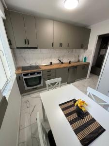 a kitchen with a white table and white chairs at RH Mures Stay in Târgu-Mureş +8 photos