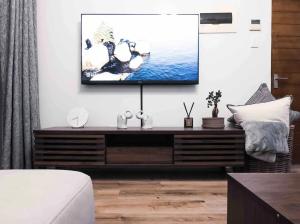 a living room with a tv on a wall at Luxurious 2 bedroom Apartment! in Centurion