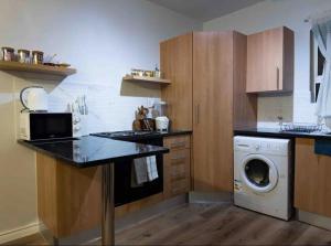 a kitchen with a washer and a washing machine at Luxurious 2 bedroom Apartment! in Centurion