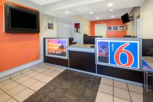 a fast food restaurant with a bar with a tv on the wall at Jurupa Valley, CA - Riverside West 