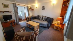 a living room with a couch and a table at Rhumhor in Bunessan