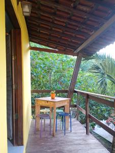 a table and chairs on the porch of a house at Casinhas de Pipa Miró in Pipa