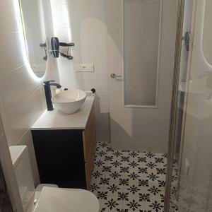 a bathroom with a sink and a toilet and a mirror at El Gobernador II in Villanueva de los Infantes +12 photos