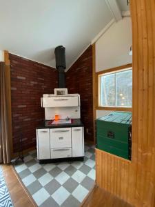 a kitchen with a stove in a room at Spa and River - Le Petit Cocon in Chateau Richer +28 photos