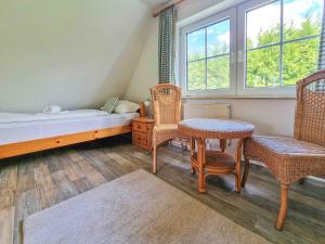 a bedroom with a bed and a table and chairs at Gretel in Greetsiel