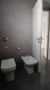 a bathroom with a toilet and a sink at aleyluna in Berrotarán +1 photo