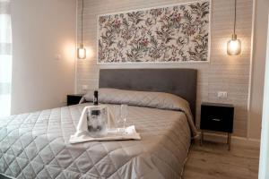 a bedroom with a bed with a bottle of wine on it at La Vecchia Taverna - Hotel Restaurant Catering in Oliveto Citra