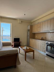a living room with a couch and a table at k&k apartament in Sarandë