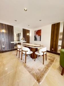 a living room with a table and chairs at شقة على النيل مطله على ممشى اهل مصر in Cairo