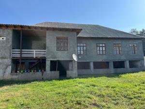 a house with a grassy field in front of it at Home in Gabala