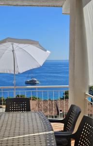 a table and chairs with a view of the ocean at Apartments Lusi in Brela
