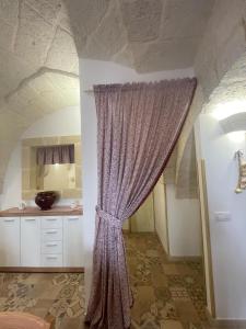 a room with a purple curtain in a kitchen at House Aurora in Fasano