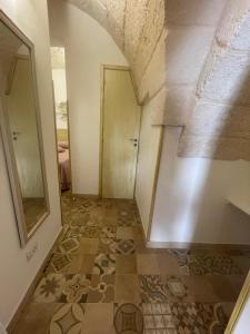 a hallway with a tile floor and a door at House Aurora in Fasano