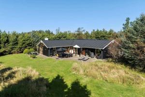 布洛克胡斯BL1718-Blokhus-Ronliensvej-16的一座带庭院的草山上的房子