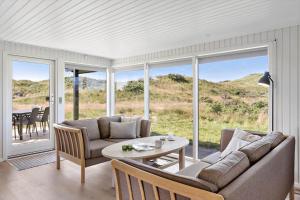 a living room with a couch and a table at BL1326-Saltum-Svendborgvej-19 in Saltum +12 photos