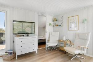 a room with two chairs and a desk and a television at BL1326-Saltum-Svendborgvej-19 in Saltum