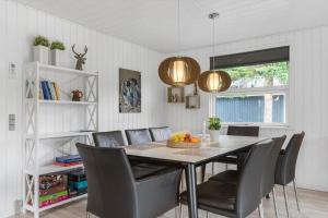a dining room with a table and chairs at BL1487-Saltum-Brune-Banke-7 in Saltum