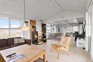 a living room with a couch and a table at BL1455-Blokhus-Pirupshvarrekrogen-6 in Blokhus