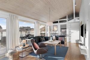 a living room with a couch and a table at BL738-Saltum-Graabakken-53 in Saltum
