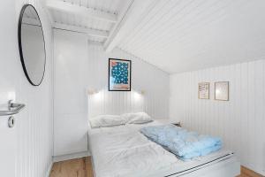 a bed in a white room with a mirror at BL738-Saltum-Graabakken-53 in Saltum +23 photos