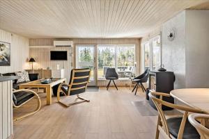a living room with a table and chairs at BL1361-Saltum-Jaerens-Rev-Sydvest-8 in Saltum