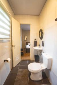 a bathroom with a toilet and a sink at FOREVER SIARGAO in General Luna +30 photos