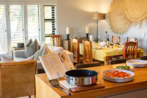 a dining room with a table with food on it at MOS- Palmiet in Kleinmond