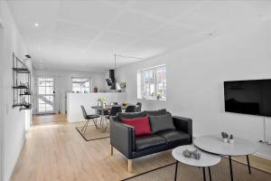 a living room with a couch and a table at BL1520-Blokhus-Klitgaardsvej-3-B in Blokhus