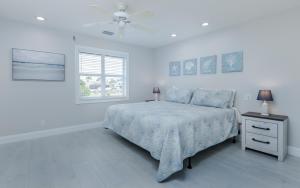 a white bedroom with a bed and a window at Rock'n Waterfront in Cape Coral +26 photos