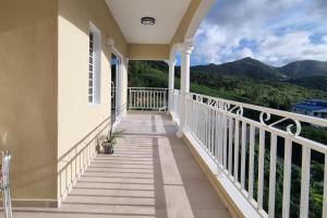 a balcony of a house with a view of the mountains at Condo with Pool - Sleeps 8 & bbq facilities in Philipsburg