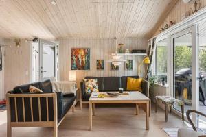 a living room with a couch and a table at BL1466-Pandrup-Lunekrogen-14 in Pandrup +28 photos