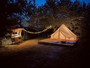 a tent sitting on a wooden platform with lights at Jelena in Kutná Hora