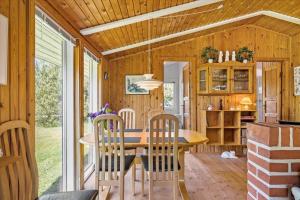 a dining room and kitchen of a tiny house at BL410-Saltum-Store-Fiskerbanke-4 in Saltum +14 photos