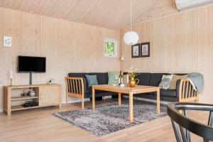 a living room with a couch and a table at BL1399-Saltum-Laustvej-30 in Saltum