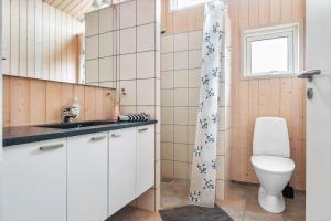 a bathroom with a toilet and a sink at BL1399-Saltum-Laustvej-30 in Saltum +25 photos