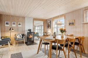 uma sala de estar com uma mesa e uma lareira em BL709-Blokhus-Kr-Thomsensvej-5 em Blokhus