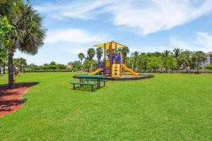 a playground with a slide in a park at Sunny Sky Vibes in Fort Myers