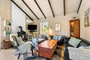 a living room with a couch and a table at BL1666-Saltum-Vikingebanke-5 in Saltum