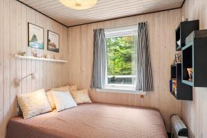 a bed in a room with a window at BL1666-Saltum-Vikingebanke-5 in Saltum