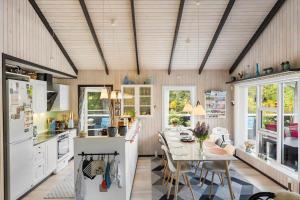 a kitchen with a table and a dining room at BL1666-Saltum-Vikingebanke-5 in Saltum