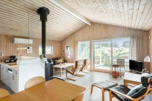 a kitchen and living room with a table and chairs at BL1462-Saltum-Revlingevej-32 in Saltum