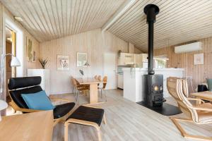a living room with a wood stove in a room at BL1462-Saltum-Revlingevej-32 in Saltum