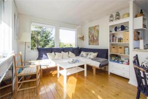 a living room with a blue couch and a table at BL435-Pandrup-Villadsvej-30 in Pandrup