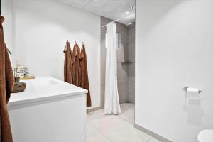 a bathroom with a sink and a shower at BL1355-Blokhus-Ribergaardsvej-24 in Blokhus +34 photos
