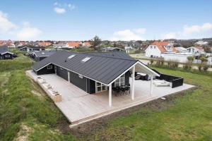 an overhead view of a black house with a deck at BL1355-Blokhus-Ribergaardsvej-24 in Blokhus